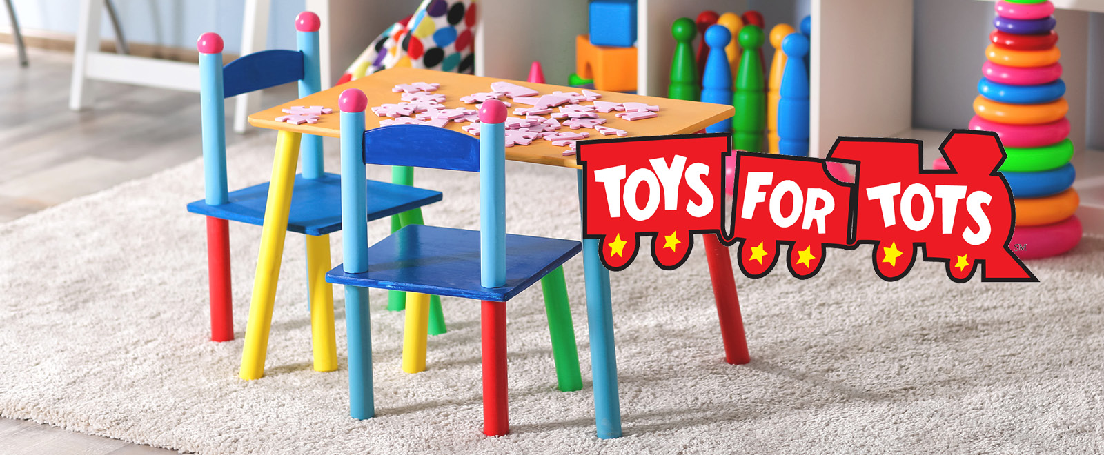 Toys for Tots train logo in playroom with toys